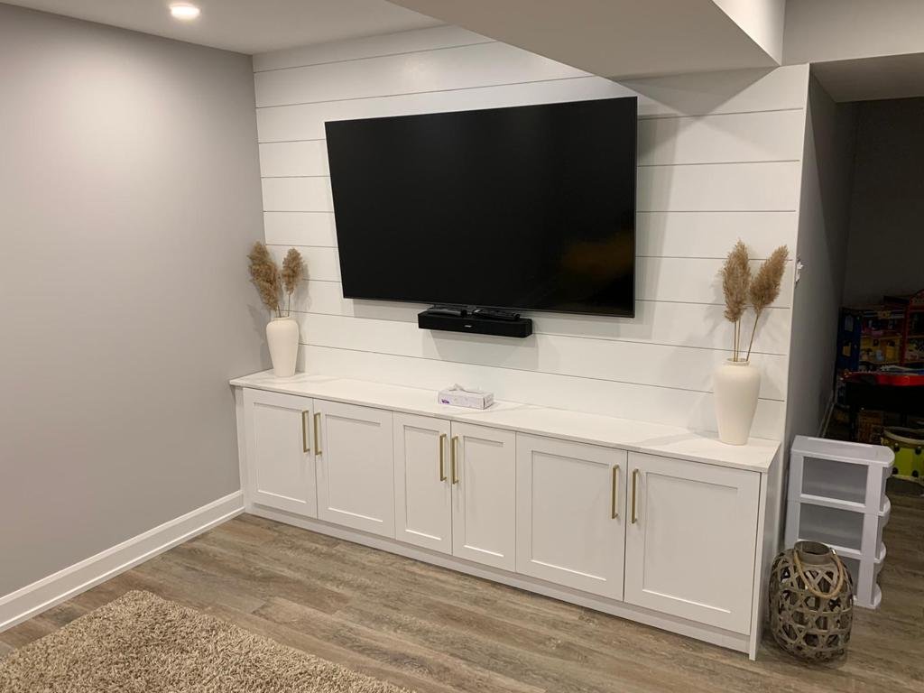 Wall-to-wall white media cabinet installation